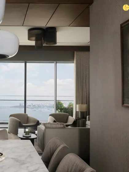 A view from the dining area into the living room at 'Pad by the Bay.' The open layout and consistent material palette create a sense of flow, while large windows connect the interior to the expansive sea and city skyline.