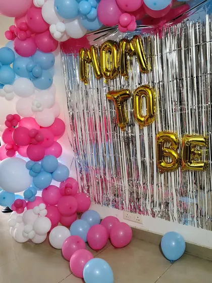 Another angle of the 'Mom to Be' backdrop, showing how the balloon garland frames the foil letters and curtain.