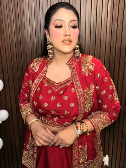 A final portrait of the client, looking absolutely radiant in her red outfit and gold jhumkas.
