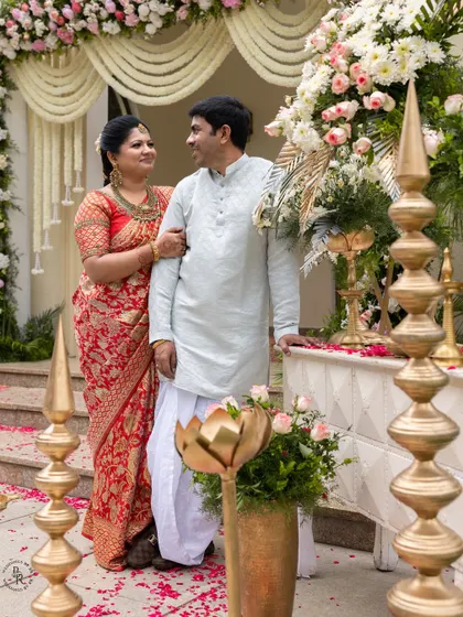 Another portrait of the parents at the ear piercing ceremony, framed by the elegant decor and flowers.