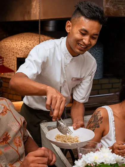 Our staff serving freshly made pasta during a themed brunch. We ensure service is as delightful as the food, adding a personal touch to your dining experience.