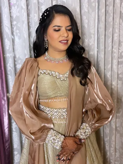 Bronzed to perfection. For my beautiful client's special event, I created a warm, bronzed makeup look with defined eyes and soft waves, making her glow from the inside out.