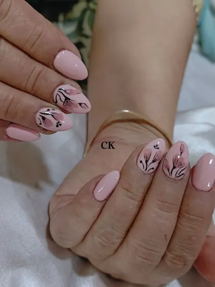 An example of my hand-painting skills. This design features delicate, translucent flowers painted on a soft pink base.