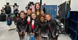 Some of our youngest competitors with a coach, enjoying the experience at the H-Town meet.