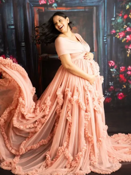A dynamic shot with a hair flip and fabric toss. This captures a moment of pure joy and energy during the maternity session.