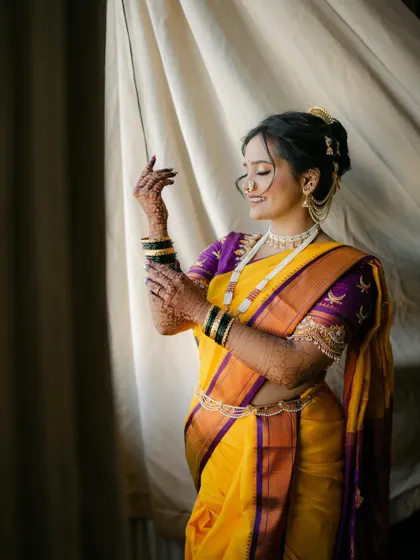 A graceful portrait. The soft makeup and elegant nauvari drape create a look that is both classic and stunning.