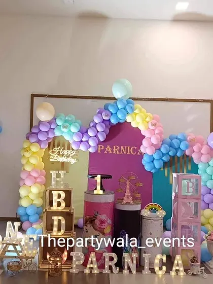 A pastel fairy tale theme with a rainbow balloon arch and 'HBD' blocks.
