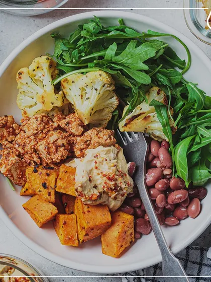 A vibrant bowl of roasted sweet potatoes, kidney beans, paneer scramble, and fresh arugula. This meal is a fantastic combination of protein, complex carbs, and healthy fats.