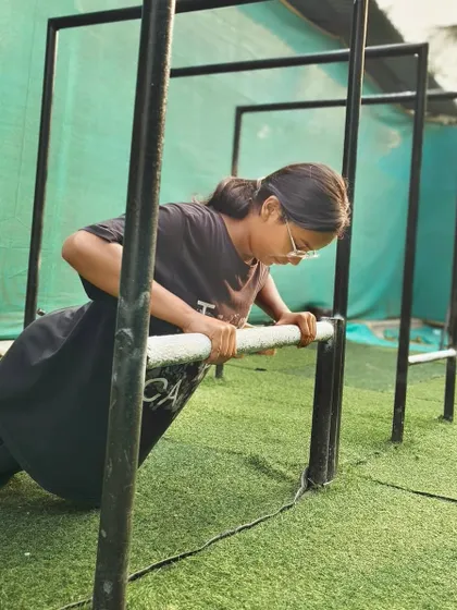 Practicing incline push-ups on the parallel bars, a great progression for building the strength for full push-ups.