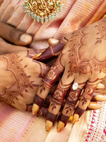 A beautiful close-up of a mature henna stain. The deep color provides a stunning contrast against the bride's skin and her traditional bangles.