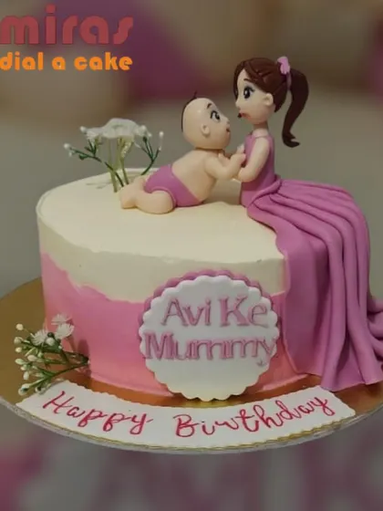 A touching cake celebrating a mother's birthday from her baby. The design features a figurine of a mother and child, capturing a moment of pure love.