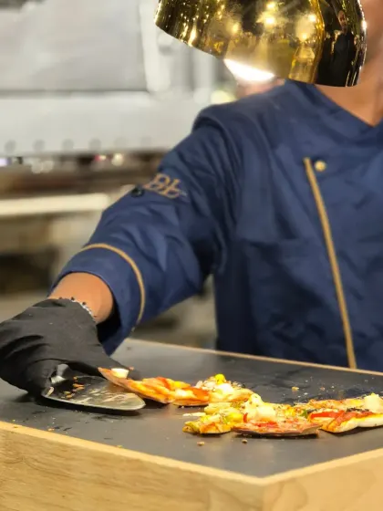 A freshly baked pizza is sliced and served at one of our live continental stations. Our chefs ensure every slice has the perfect cheese pull and is ready to be enjoyed immediately.