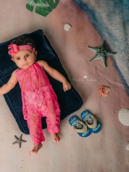 A full view of the beach setup for this 4-month-old. I use creative backdrops and props to bring the seaside right into my studio.