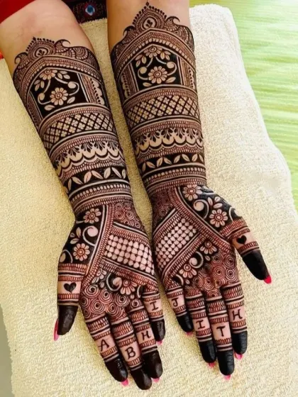 Personalize your bridal mehndi with your and your partner's names. In this design, I have woven the letters of their names into the fingertips, adding a unique and modern touch to a traditional pattern.