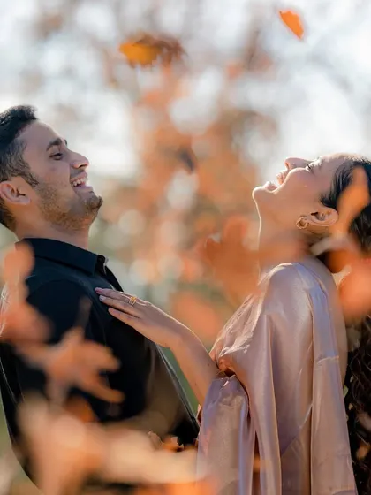 A candid moment of pure joy as a couple shares a laugh, surrounded by the warm, soft light of an autumn forest. This is the kind of unposed, genuine emotion I love to capture in my lifestyle portrait sessions.