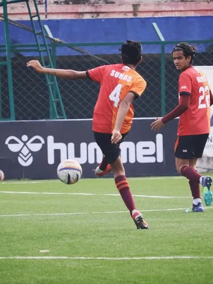 A player controlling a high ball. First touch and ball control are fundamental skills that we practice relentlessly.