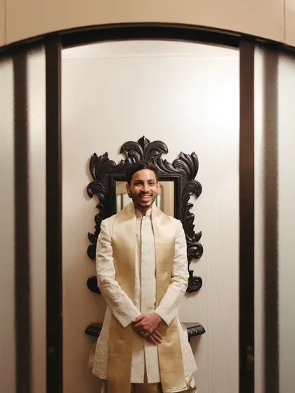 The groom looking dapper and ready for his wedding, captured in a simple yet elegant portrait.
