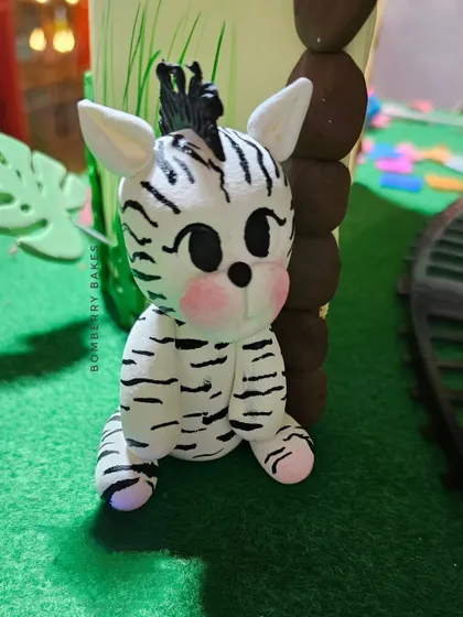 An adorable baby zebra figurine, hand-painted with delicate stripes. This is a great example of combining sculpting and painting techniques for a more detailed finish.