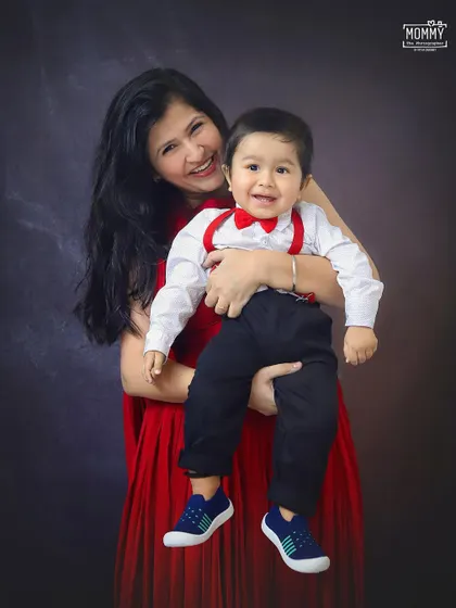 The biggest, happiest smile! A mother holds her little boy, and his joyful expression is absolutely infectious. A beautiful mother and son portrait.