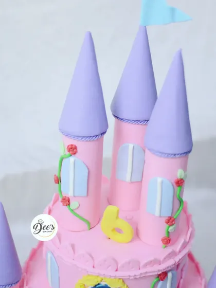 The castle turrets are carefully crafted and colored to create a beautiful, whimsical look for this princess-themed cake.