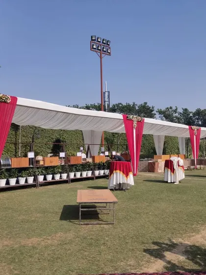 Here you can see a catering and buffet station set up under a tent for an outdoor event. I ensure that even functional areas are neatly presented and integrated into the overall decor theme.