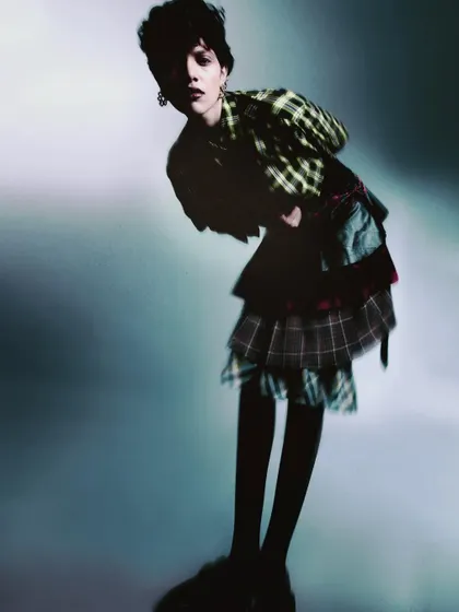 Another motion-filled shot from the same series, with the model bent over. The soft focus and movement create a dreamy, slightly chaotic atmosphere that is full of personality.