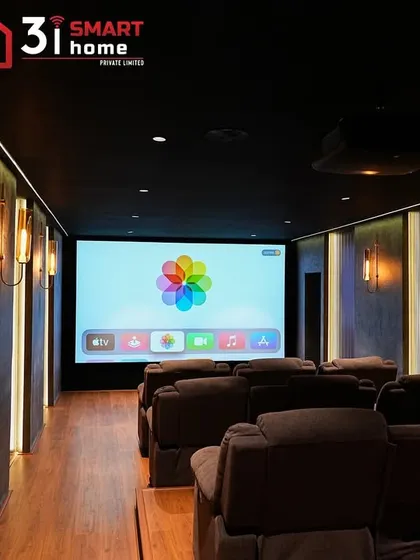 A full view of the Chennai theater, showing the large screen, multiple rows of recliners, and the carefully designed lighting scheme that enhances the room's warm and luxurious feel.