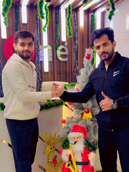 A handshake celebrating both fitness progress and the festive season. Our community is built on support and camaraderie.