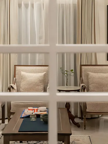 A final peek at our all-white interior series, viewed through the panes of a classic French door. This framing creates a sense of depth and anticipation.