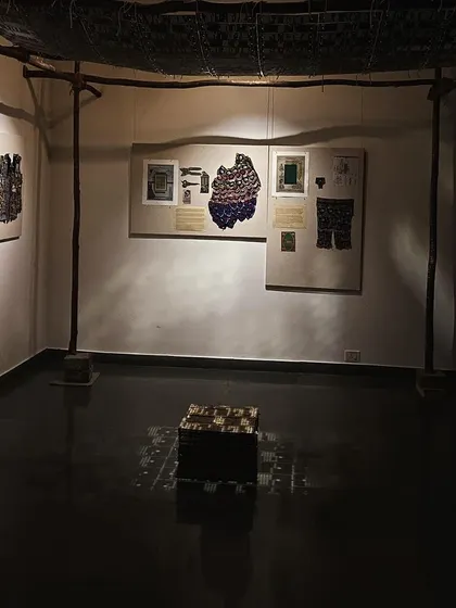 A corner of the 'WEAVING LIGHT' installation, showing the moody, atmospheric lighting.