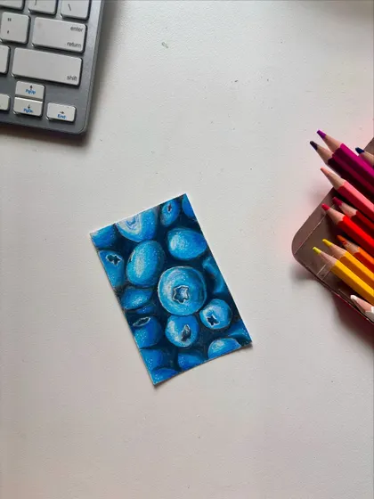 The finished blueberry drawing, showing the rich blues and highlights.