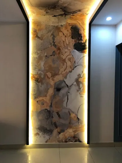 A close-up of the wallpaper on the pillar, highlighting the abstract pattern and the glow from the integrated lighting.