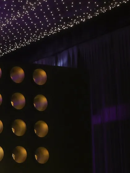 The interplay of the starlit ceiling and the textured wall lighting creates a multi-layered and immersive visual experience for guests.