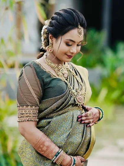 The serene glow of a mother-to-be is priceless. Here, my intricate henna work beautifully complements her joy as she looks down at her baby bump during her baby shower photoshoot.