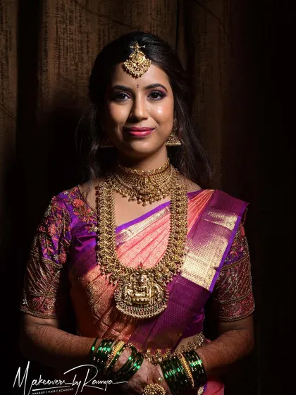 Santhoshi looking directly at the camera, her confidence and beauty shining through.