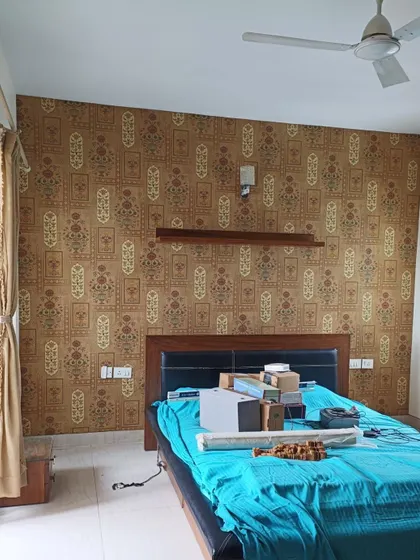 A traditional Indian block-print style wallpaper in earthy tones, creating a warm and ethnic feel in the bedroom.