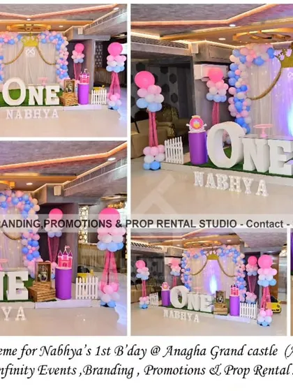 This simple princess theme for a first birthday at Anagha Grand Castle features a lovely pink, blue, and white color palette. The backdrop includes curtains and a balloon garland with a crown accent, complemented by a "ONE" table and themed balloon pillars.