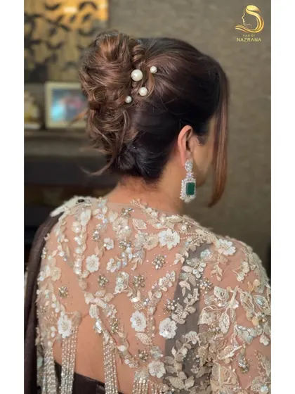 The beauty is in the details. This textured French twist is elevated with delicate pearl pins, creating a timeless and sophisticated updo that’s perfect for a reception or elegant evening event.