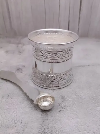 A German silver panchapatra set, including the glass and spoon (uddharani). This is an essential item for distributing holy water during pooja.