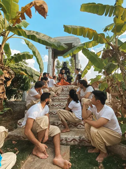 I sit with students on the steps of our Hanuman shrine, surrounded by banana trees. These informal gatherings are where some of the most profound teachings and connections happen.