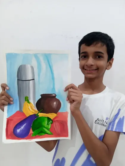 This is Ishan, a 9th-grade student, with his completed object drawing. He used watercolours on paper to create this still life composition, showing great control over the medium.