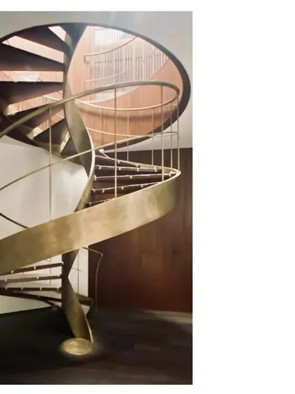 A sculptural spiral staircase made of aged brass and wood. We love the details, the junctions, and the way a handrail can split and find its own support. It is so satisfying when it all comes together.