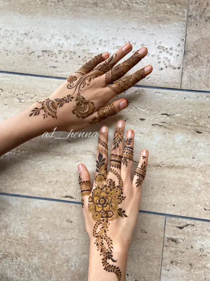 A simple yet elegant design with a floral motif on one hand and a vine on the other.