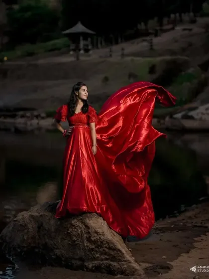 A stunning shot of our client in a red satin trail gown. The way the fabric catches the wind creates a breathtaking and powerful image.