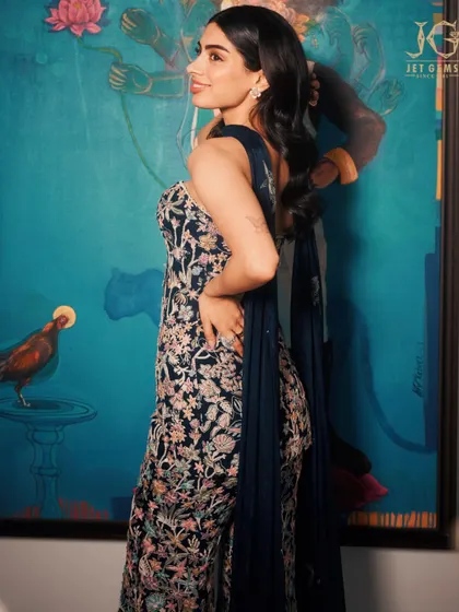 A side profile of Khushi Kapoor, showcasing the intricate floral embroidery of her dress and our sparkling diamond earrings.