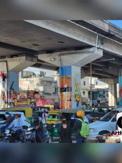 A wide shot of the Chandigarh pillar painting project in progress. You can see our artists working on multiple pillars simultaneously to transform the entire underpass area.