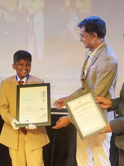 A student receives his certificate and badge of honor during the Investiture Ceremony. This moment symbolizes his commitment to his new role and the responsibilities that come with it.