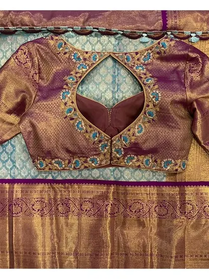 The back of the violet blouse, featuring a keyhole cutout and delicate embroidery.