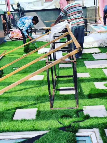 My team carefully works on the final touches for this terrace event space. The artificial grass provides a perfect, durable base for any setup.
