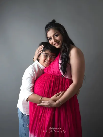 A mother embraces her son while expecting her next child. A beautiful portrait of a soon-to-be big brother and his loving mom.